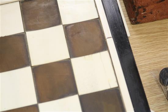 A 1930s ivory and tortoiseshell chess board and a 19th century ivory chess and draughts sets
